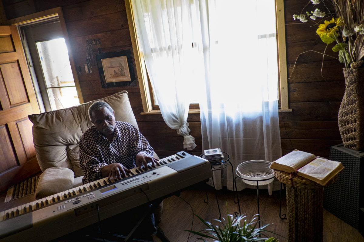 Donald "Amzi" Lightner, 63, plays music in his home in Clairton, Pa.