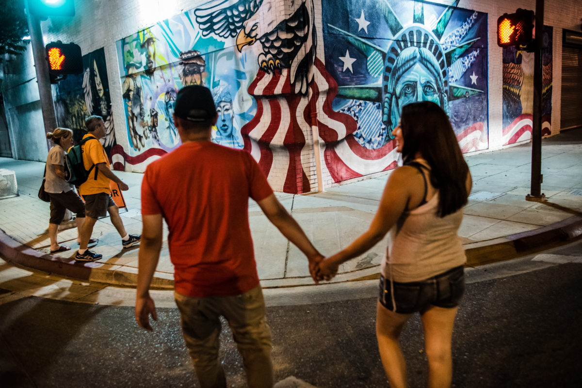 Vinson and Brittney pass an America-themed mural in Downtown Fresno.